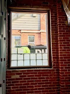 person installing window glass blocks