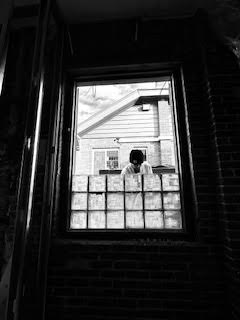 black and white image of person installing window glass blocks